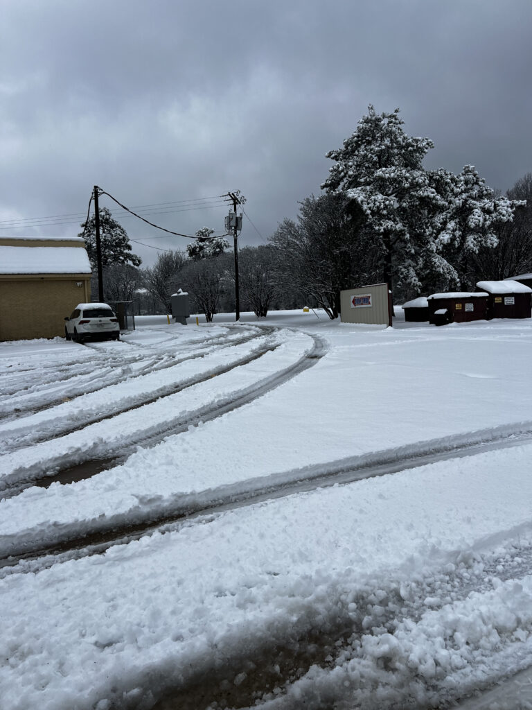 Snow covered road and property during winter storm